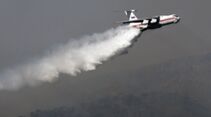 An Ilyushin-76 tanker plane sprays its l