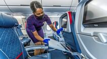 Flight Attendant checks cleanliness of plane