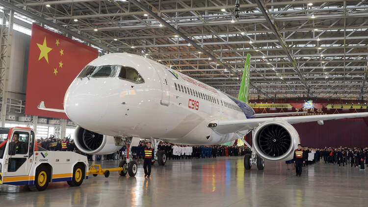 People Celebrate The Rolling Off Of The First C919 Passenger Jet Plane In China
