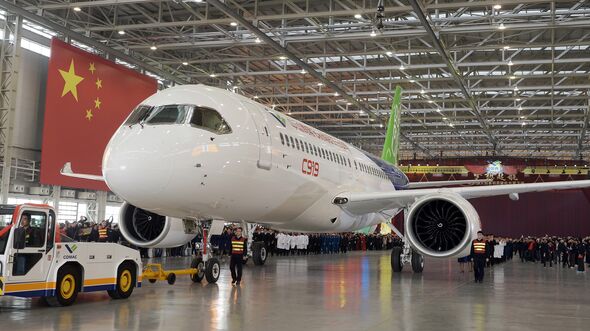 People Celebrate The Rolling Off Of The First C919 Passenger Jet Plane In China